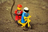 Lego characters riding a bike