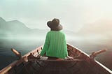 Person on a boat in the water and quietly reflecting.