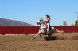 a woman riding a horse