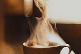 steam rising up from a cup of coffee