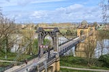 Photo of an industrial style bridge over the Lot river, located in the South West of France (Mas d’Agenais)