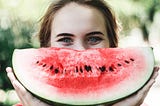 A lady with water-melon slice show excitement