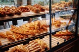 Picture of bakery cases filled with breads and rolls.