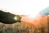 holding hands outdoors