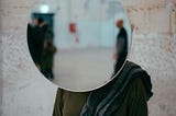 curved surveillance mirror blocking a person’s face