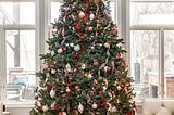 Did your Christmas tree every look as perfectly symmetrical and decorated as this one with red and white bulbs and ribbons? Mine either.