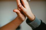 Two young boys make a friendship hand clap