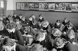 Interior of a classroom, students bent at study, Yallourn, 1947.