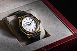 A gold watch in a display box