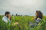 man taking photos of woman in a flowery field