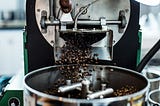 Coffee beans falling into a grinder