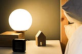calming bedroom with a soft light table lamp, clean bedside table, and fluffy white linens.