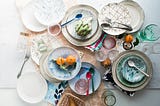 Several dishes on a table containing exotic foods