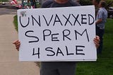 “Unvaxxed Sperm 4 Sale” reads a protest sign.