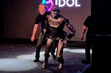 a humanoid about to fall with a guy on the back ready to pick it. It comes from the russian mega flop