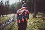 A traveler walking through a forest