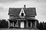 an old abandoned house in a desolate setting