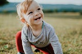 A small kid is planning to learn how to get up. This is an emblemetic of starting something new that is more resilient.