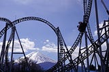 Rollercoaster with mountains in the background.