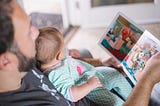 A father reading to a young child