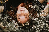 A woman resting on the grass.