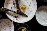 Photo of dirty dishes in a sink.