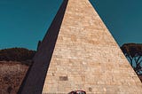 The Pyramid of Cestius, my favorite Roman landmark, right in the middle of the road.