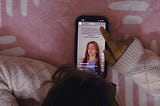 A person scrolling on a mobile phone.