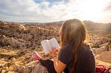 Image of woman reading in the mountains for 5 Books that Changed my Life 180°