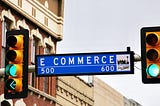 Blue city street sign stating “E COMMERCE”