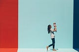 Woman walking while holding a baby up to face her