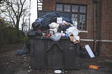 An overflowing dumpster symbolizing all of the trash that we should get rid of in the New Year