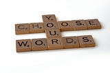 Scrabble game letters spelling out “choose your words”