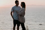 Couple enjoying each other’s company by a sea dock