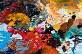 splatters of many colours of paint on a surface