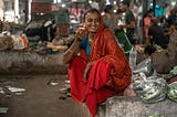 A South Asian woman is all smiles while sipping on chai