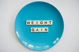 Blue plate with letters spelling weight gain