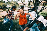 A group of kids running and playing together.