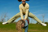 Two girls smiling and playing Leap Frog.