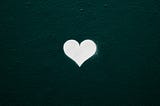 Small white heart shape with dark teal background