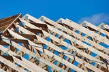 The exposed roof trusses of a home under construction shows the wood used to build them.