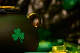 shamrock, golden beverage, leprechaun hat evoking a St. Patrick’s day party