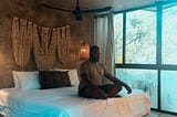 men doing meditation before sleep on the bed dim light inside of bedroom