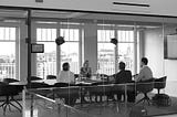 Group of people at a table in a conference room