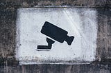 A stencil grafitti of a security camera.
