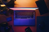 An aerial shot of a Macbook sitting on a table.