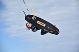 Kiteboarder Matt Maxwell performing tricks in the ocean