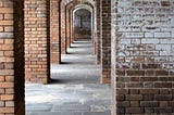 A hallway of brick arched walkways inside Fort Jefferson.