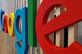 The Google sign on a wooden building.