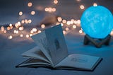 An open book with lights in the background